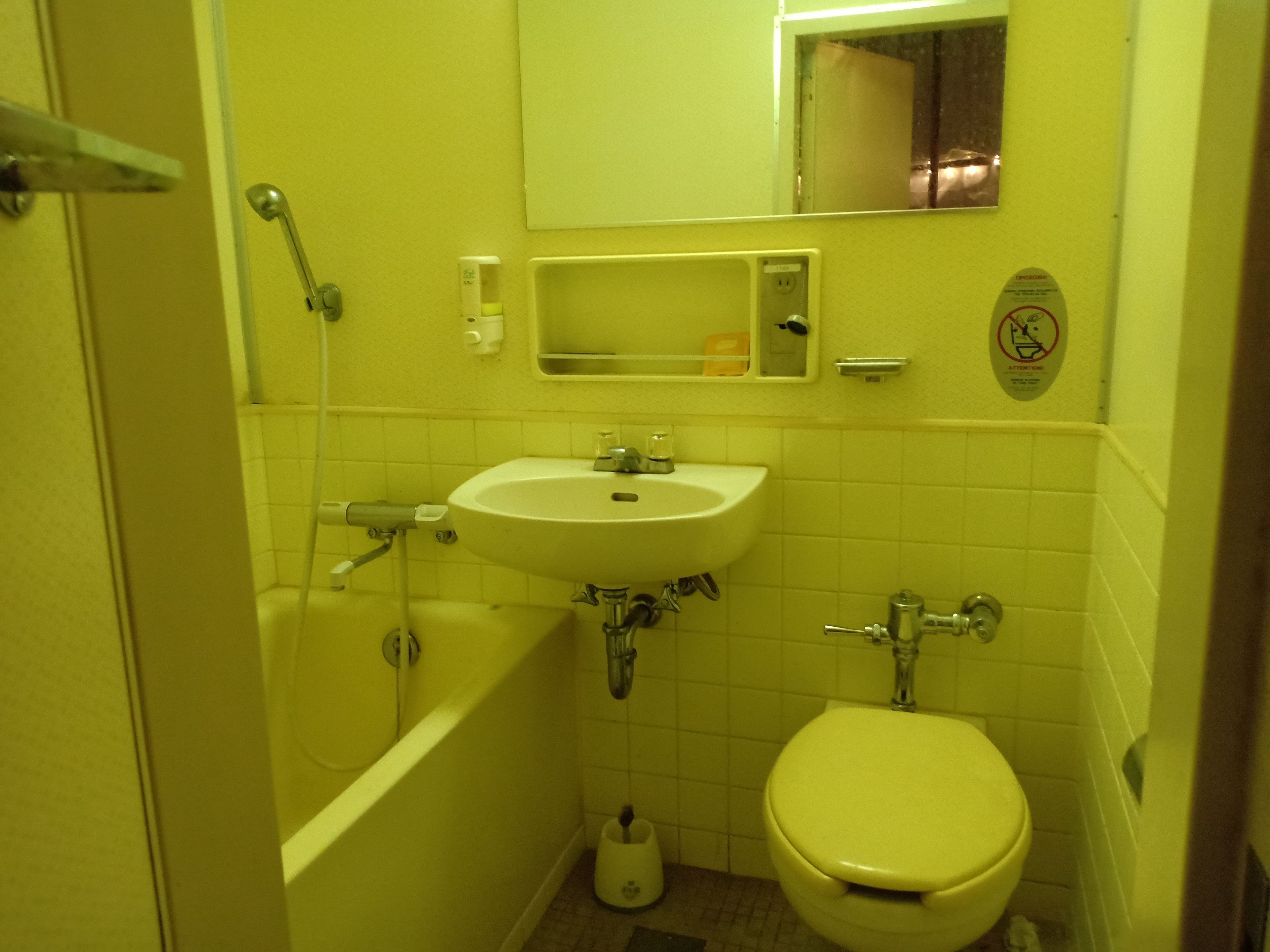 A small bathroom with a sink, toilet, and bathtub.