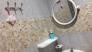 A bathroom with a sink, mirror, and towel rack. - Plainam Resort (Pranburi)