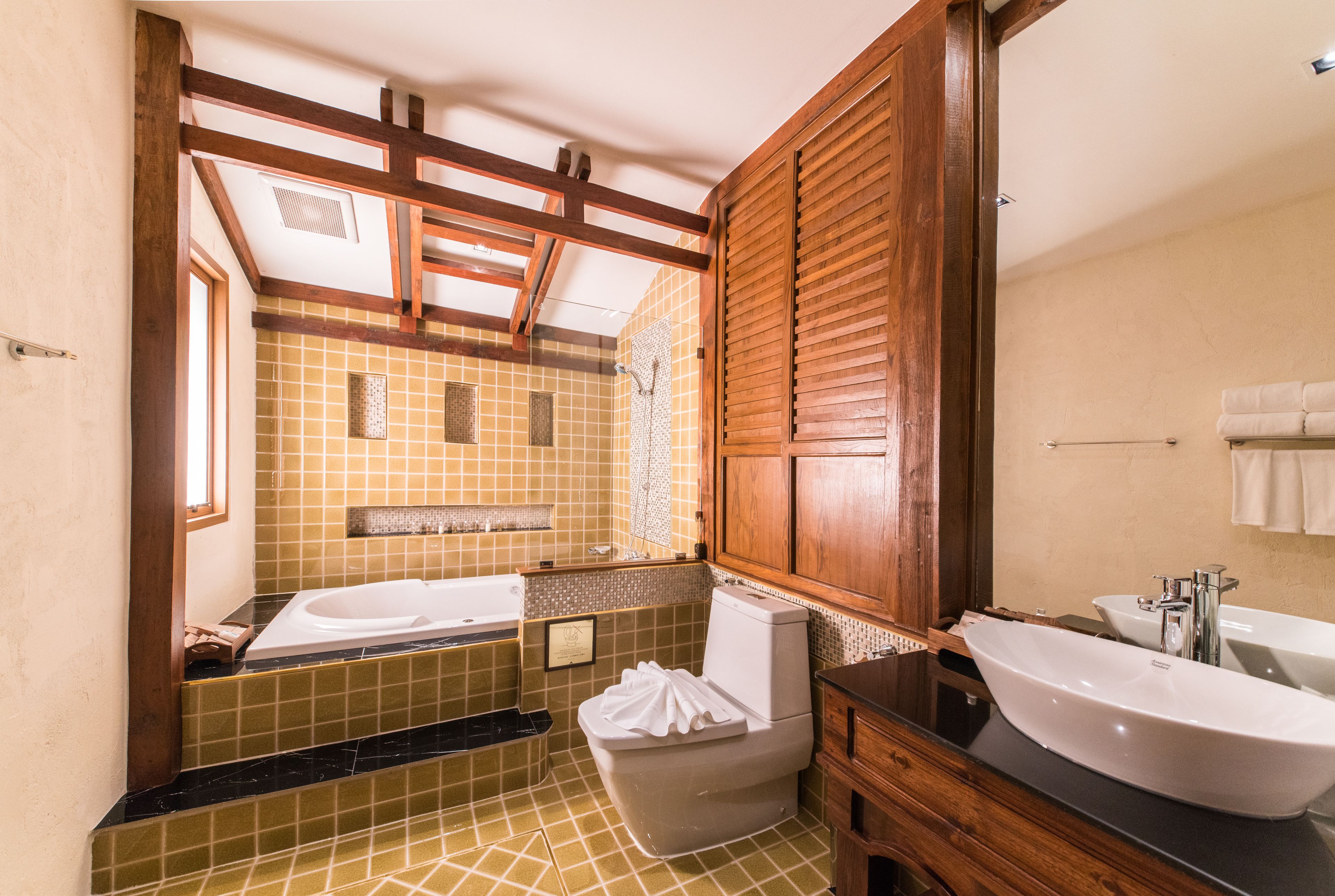 A bathroom with a bathtub, toilet, and sink.