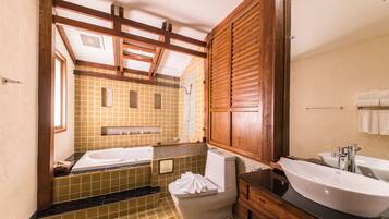 A bathroom with a bathtub, toilet, and sink.
