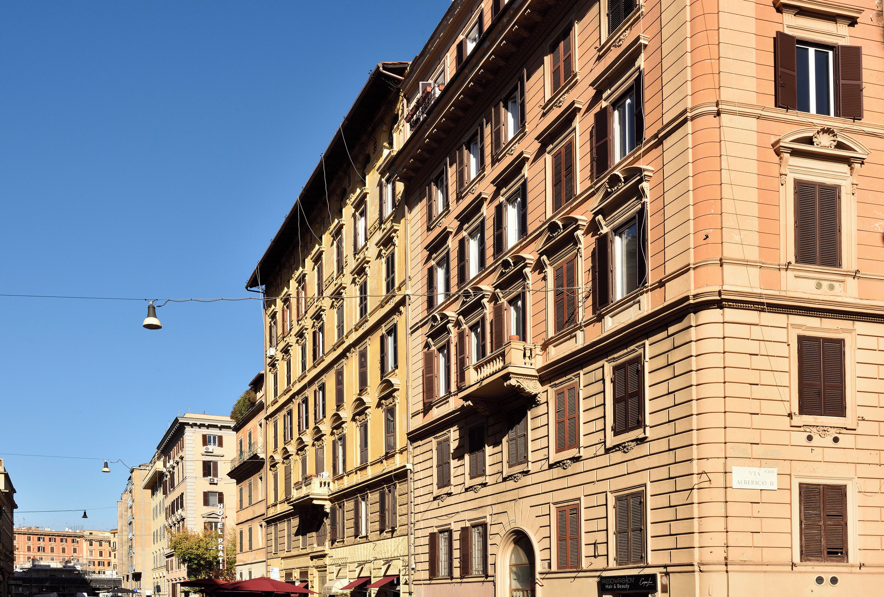 A multi-story building with classical architecture, featuring arched windows and decorative moldings.