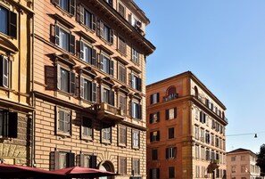 A multi-story building with a classic architectural style, featuring multiple windows and balconies. - Velantia Vaticano - Guesthouse (Rome)