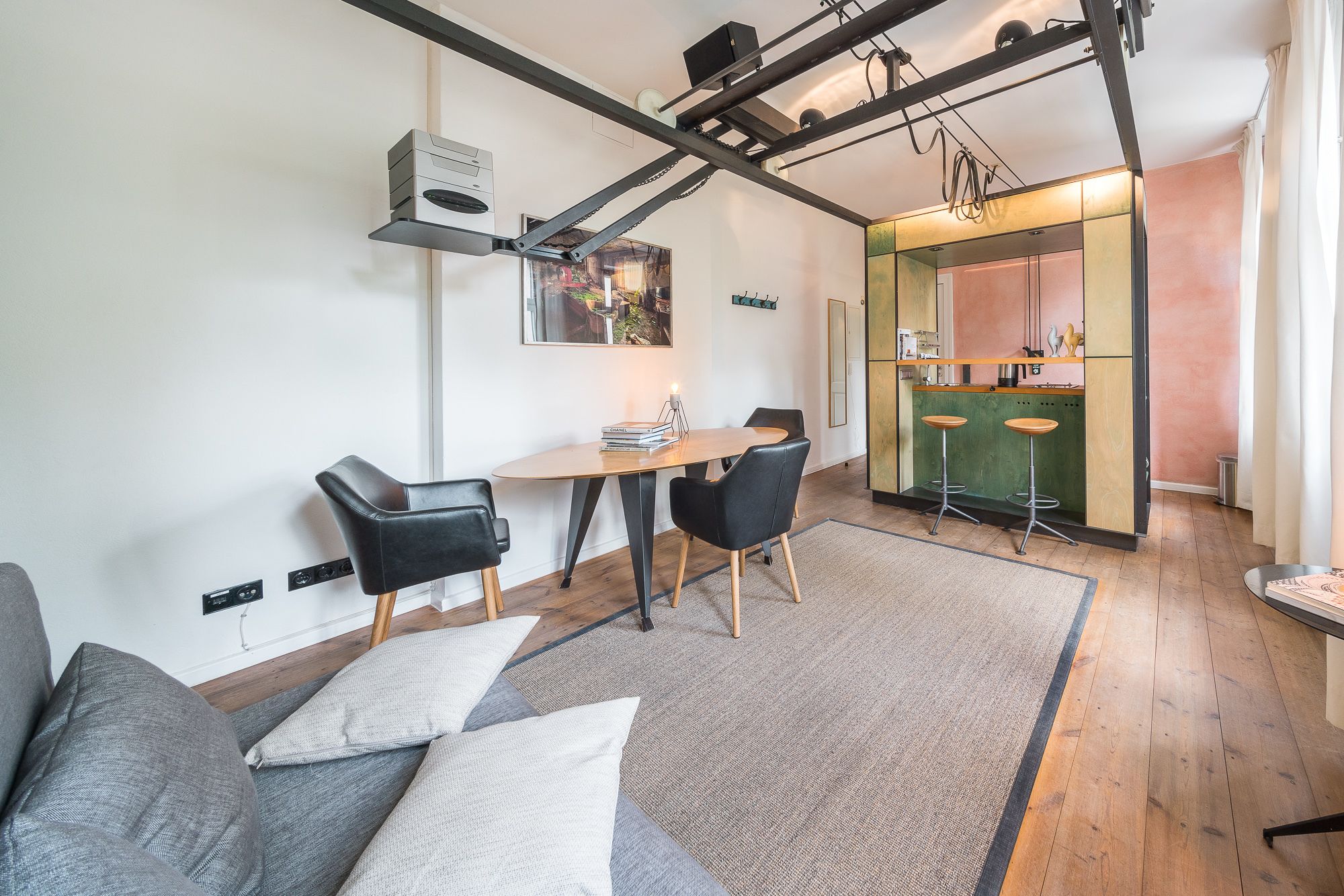 A modern living room with a dining area, kitchen, and bar area.
