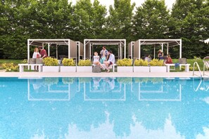 Seasonal outdoor pool, open 10:00 AM to 8:00 PM, pool umbrellas