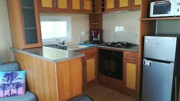 Fridge, microwave, coffee/tea maker, cookware/dishes/utensils
