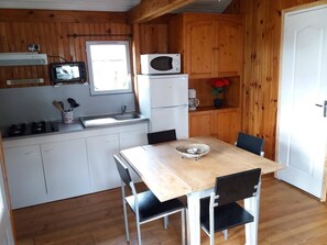 Fridge, microwave, coffee/tea maker, cookware/dishes/utensils