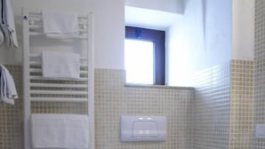 A bathroom with a bidet, toilet, and a towel rack. - Arco Michele (Putignano)