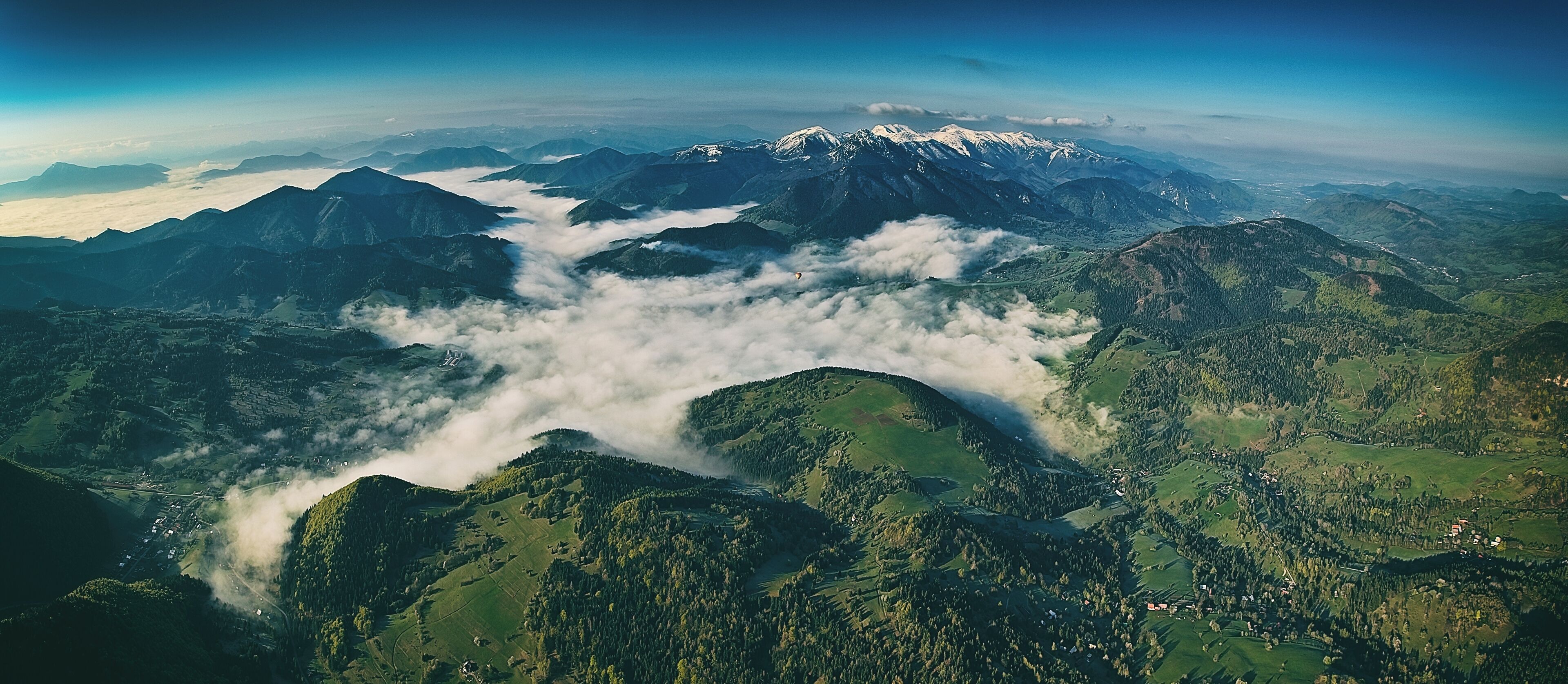 A mountainous landscape with a village nestled among the hills.