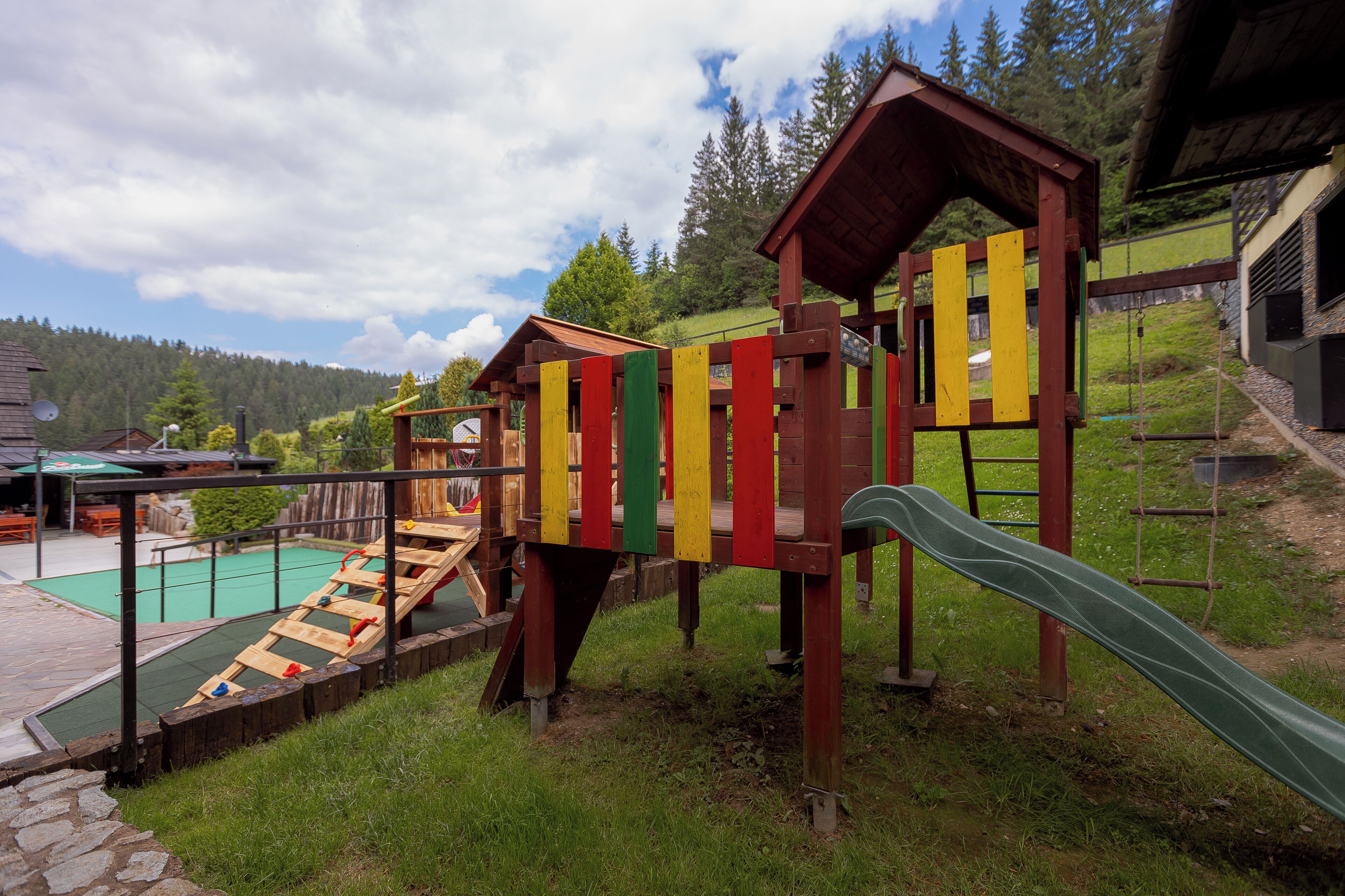 A playground with a slide and climbing structures.