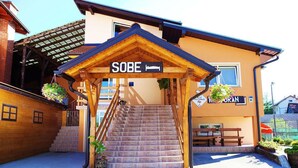 A building with a sign reading "SOBE" and a staircase leading to a covered entrance. - B&B Mreznica House DP (Duga Resa)