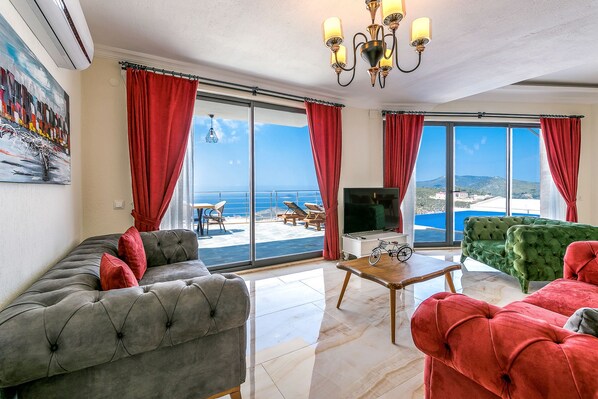 A living room with a large window, a television, and a bicycle.