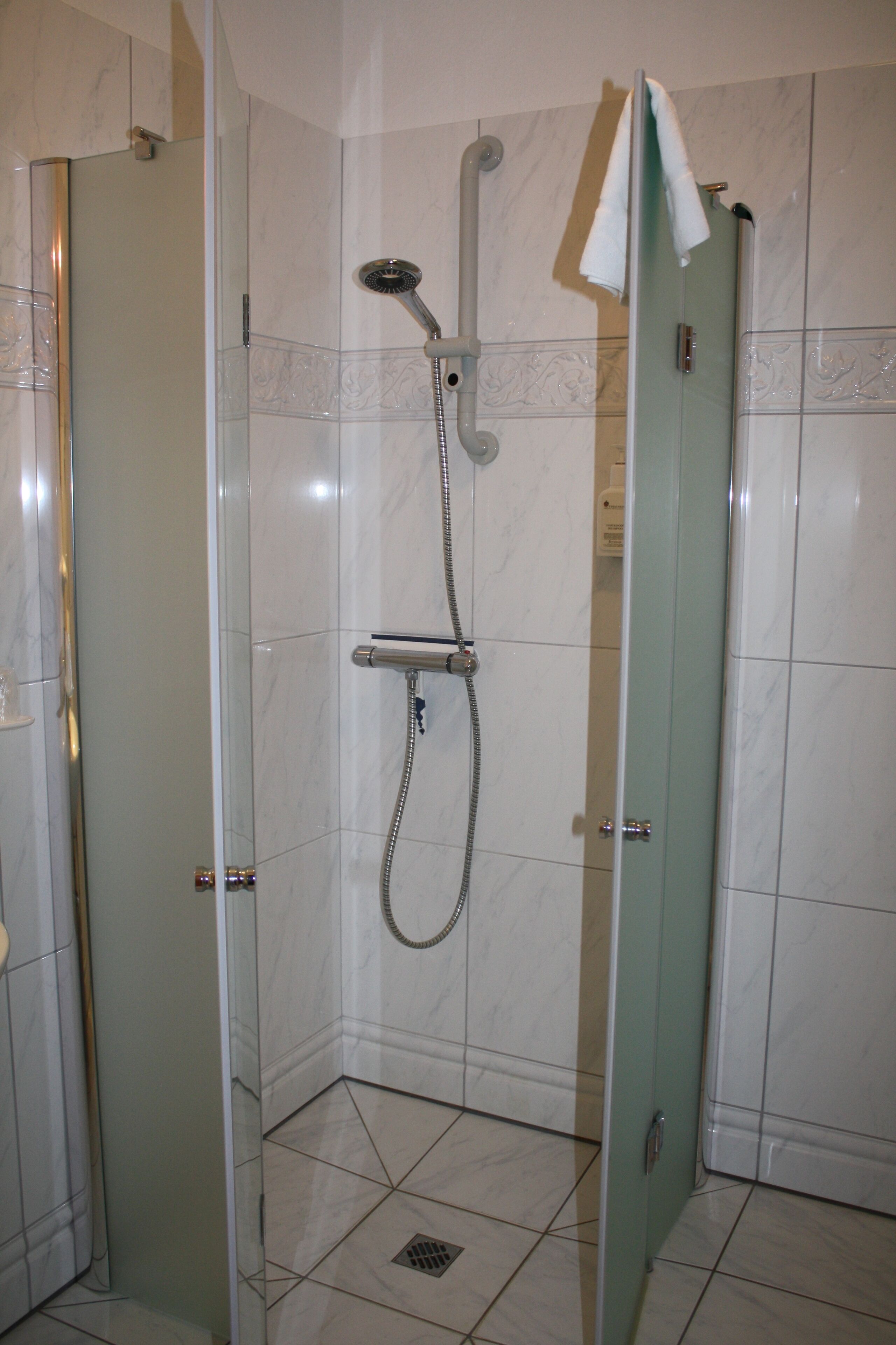 standard double room | bathroom | shower, hair dryer, soap, shampoo