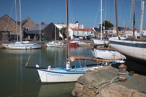Moored sailboats line the quay, offering a serene waterfront view.