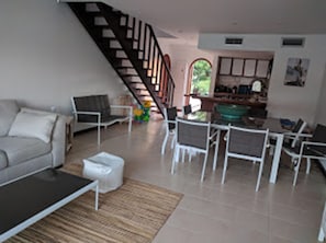 Relax in this stylish living room with a sofa set, coffee table, and dining area.
