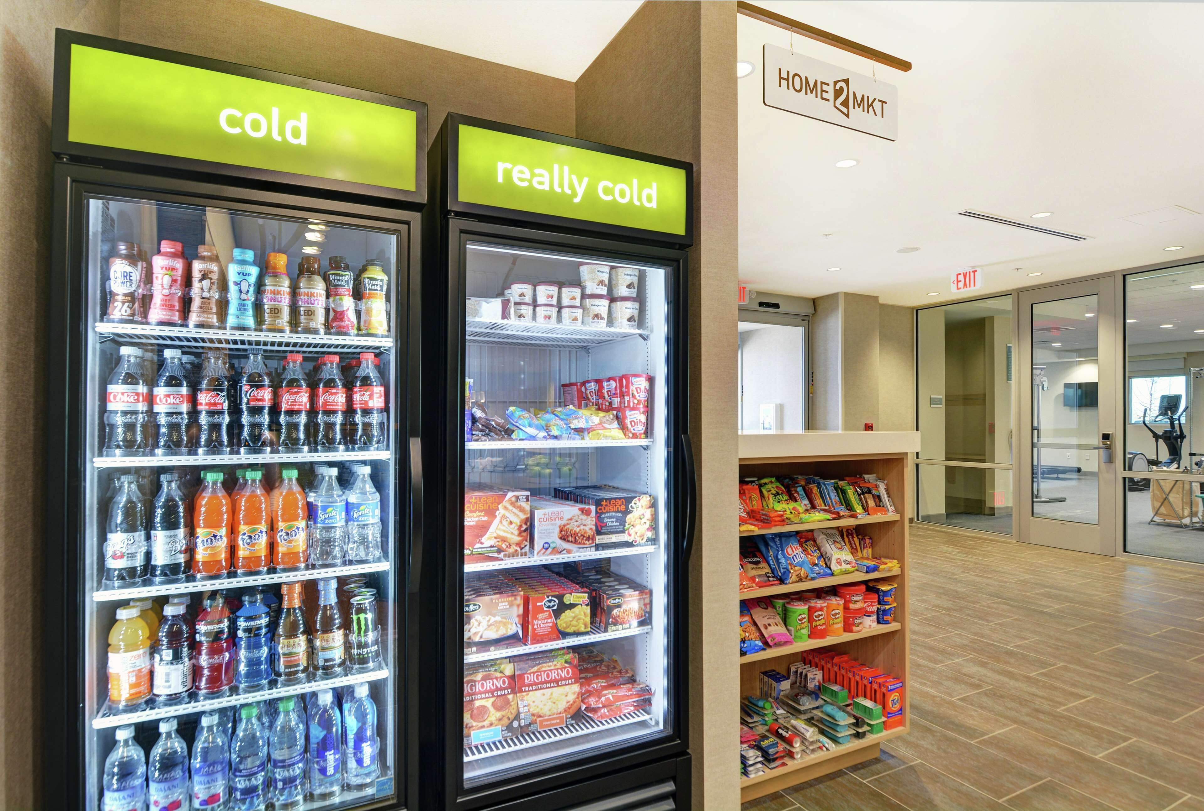 Two refrigerated beverage dispensers labeled "cold" and "really cold" with various drinks inside.