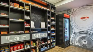 A snack display area with various packaged snacks and a chalkboard sign. - Hampton Inn Simpsonville (Simpsonville)