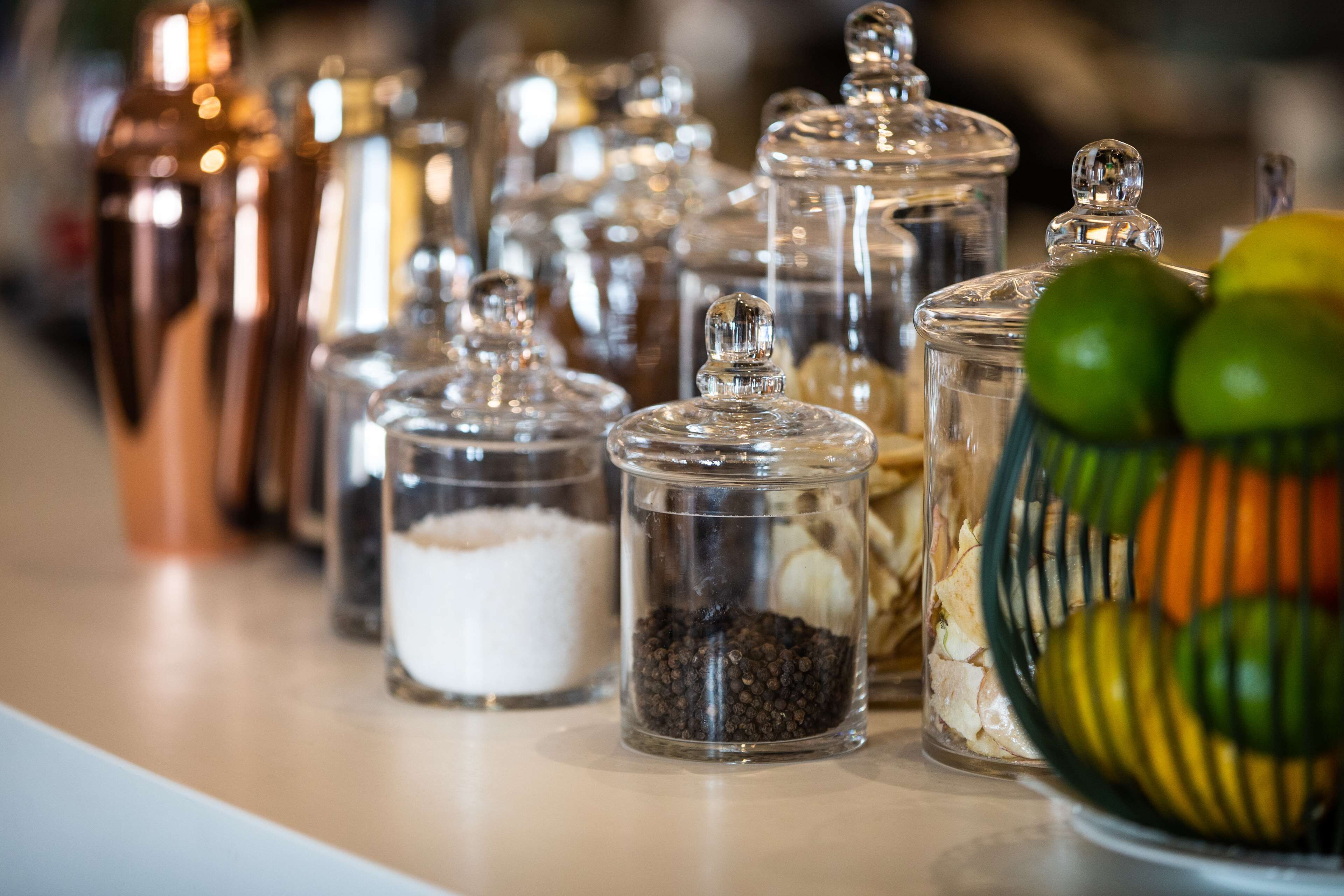 A variety of glass containers with lids, likely used for storing spices or condiments.