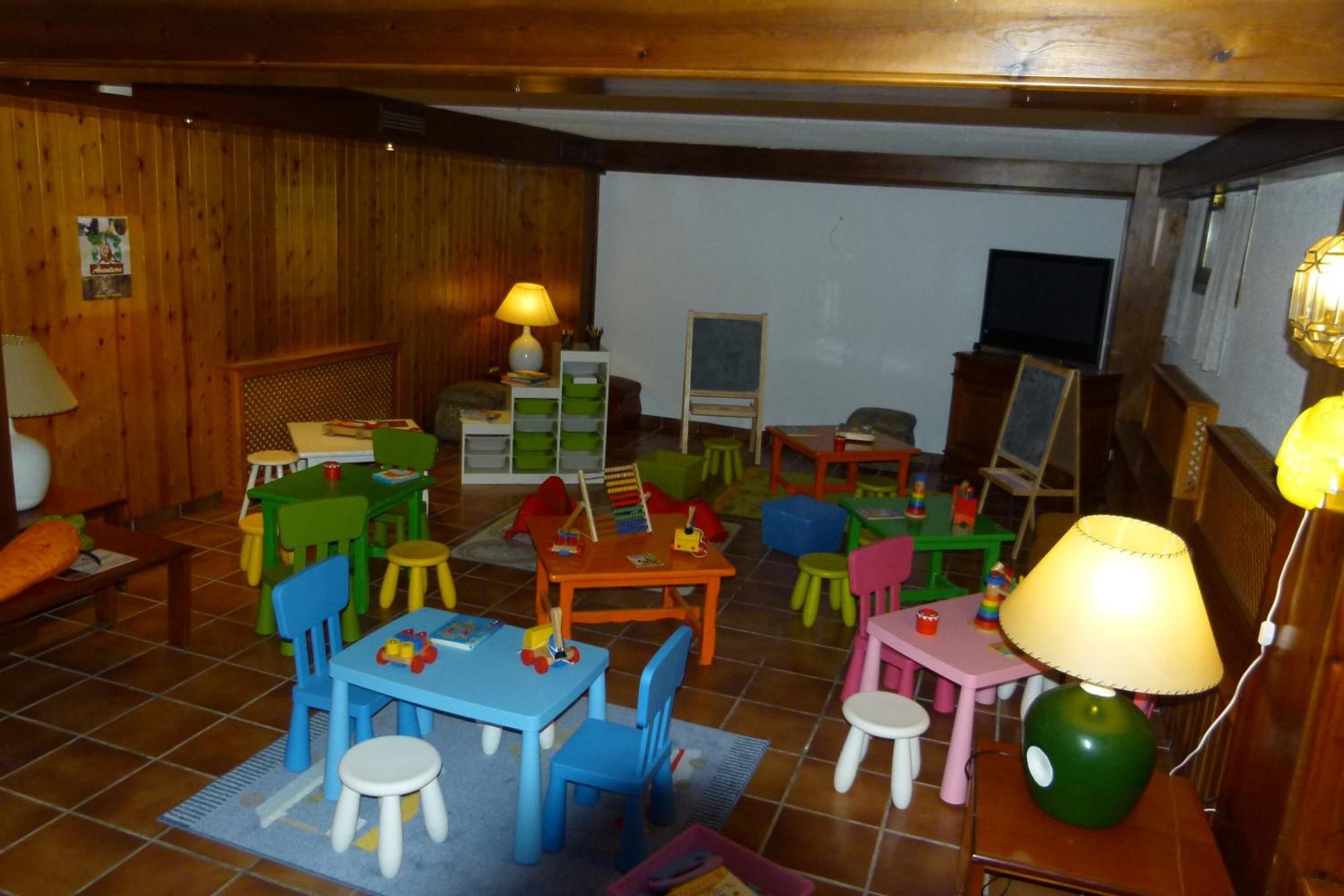 A children's playroom with colorful furniture and toys.