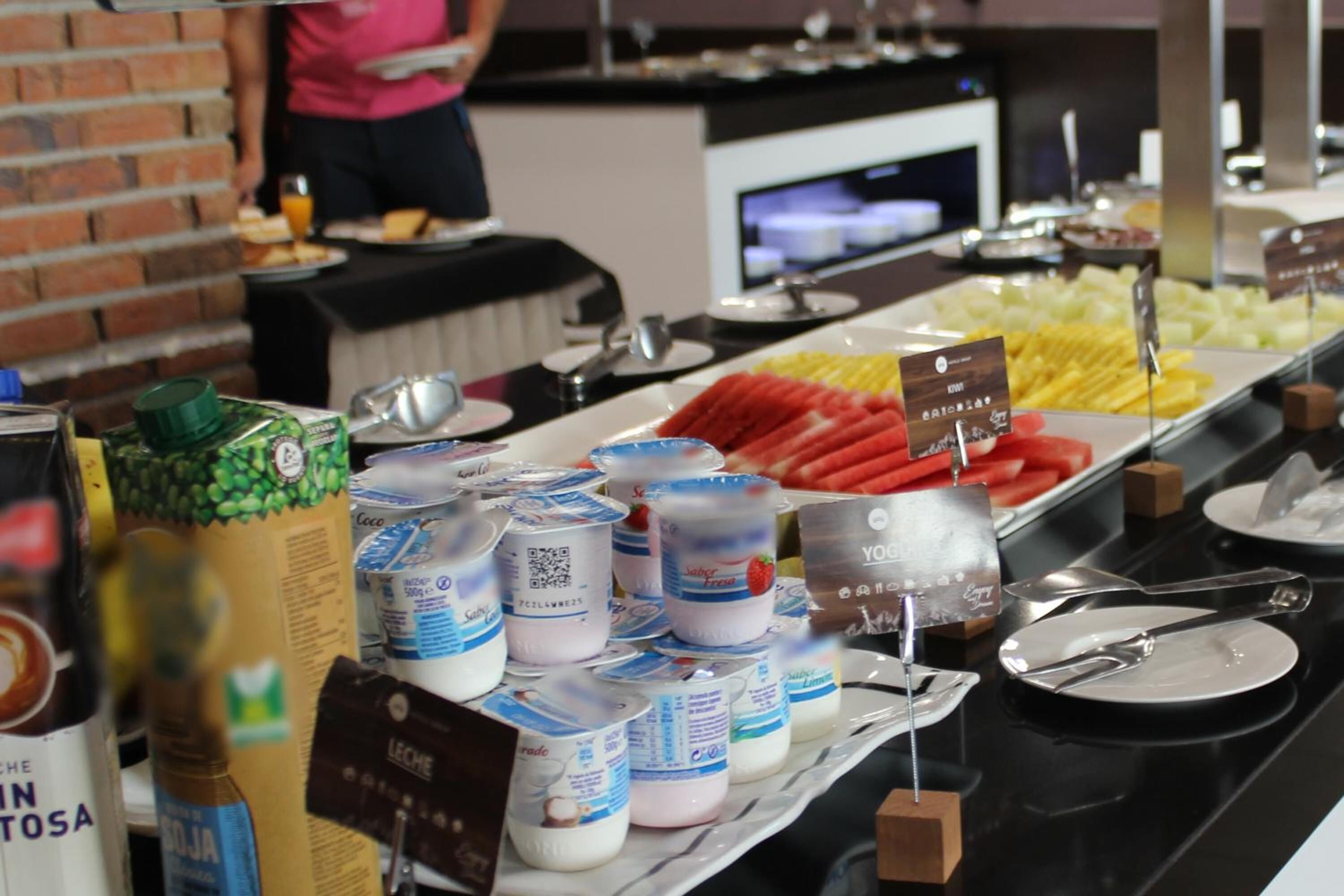 A buffet setup with various food items and condiments.