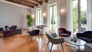 A spacious living room with a wooden ceiling, large windows, and modern furniture.