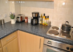 Enjoy cooking in this well-equipped kitchen with a stove, oven, and coffee maker.