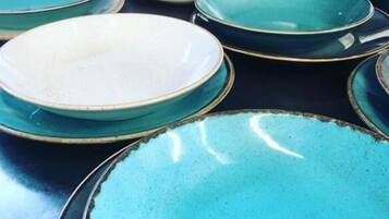 A collection of plates with a teal and white color scheme, arranged on a surface.