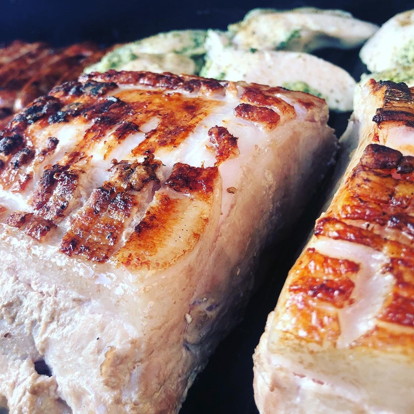 Grilled chicken breasts with visible grill marks.