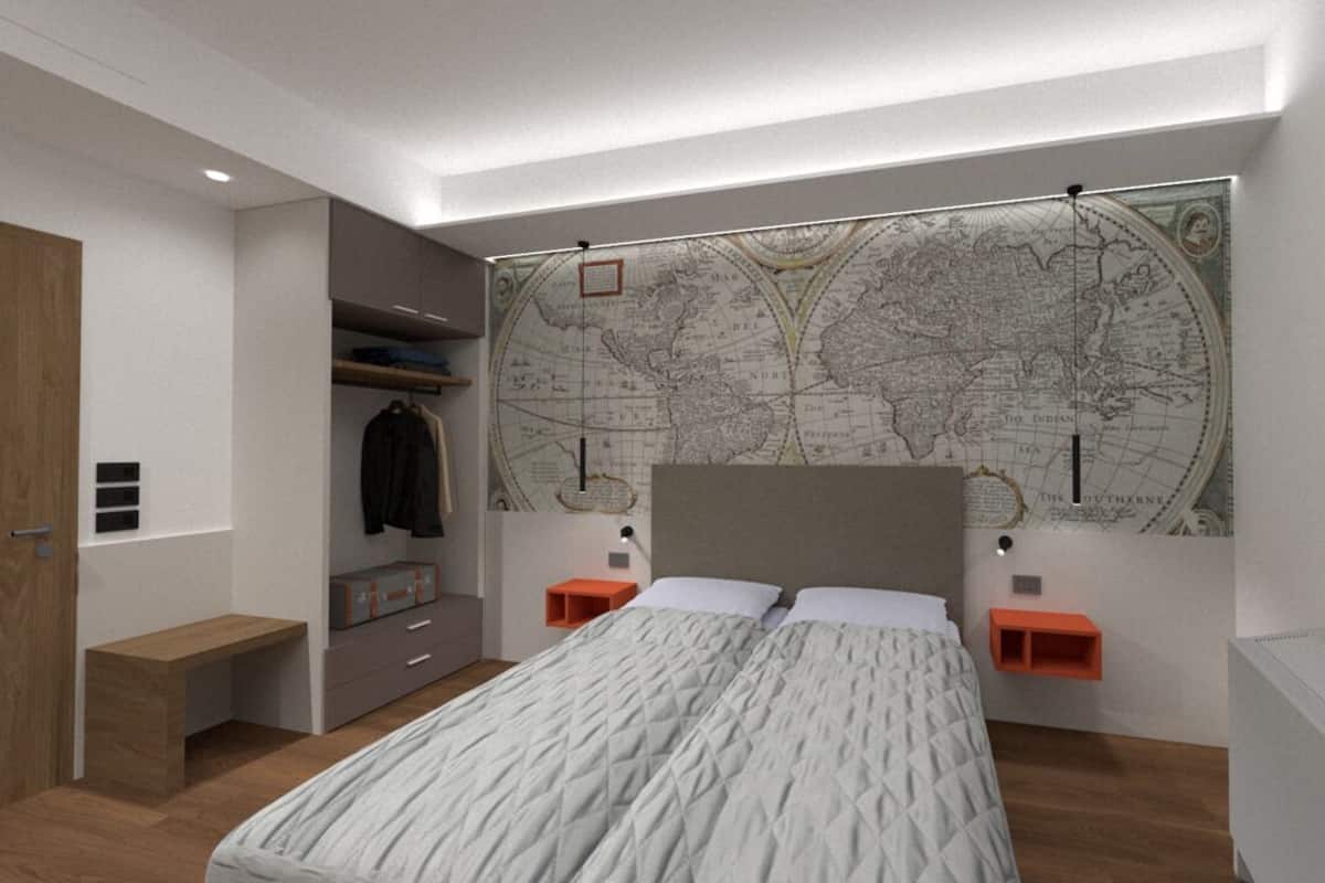 A modern bedroom with a large bed, a world map on the wall, and built-in shelving.
