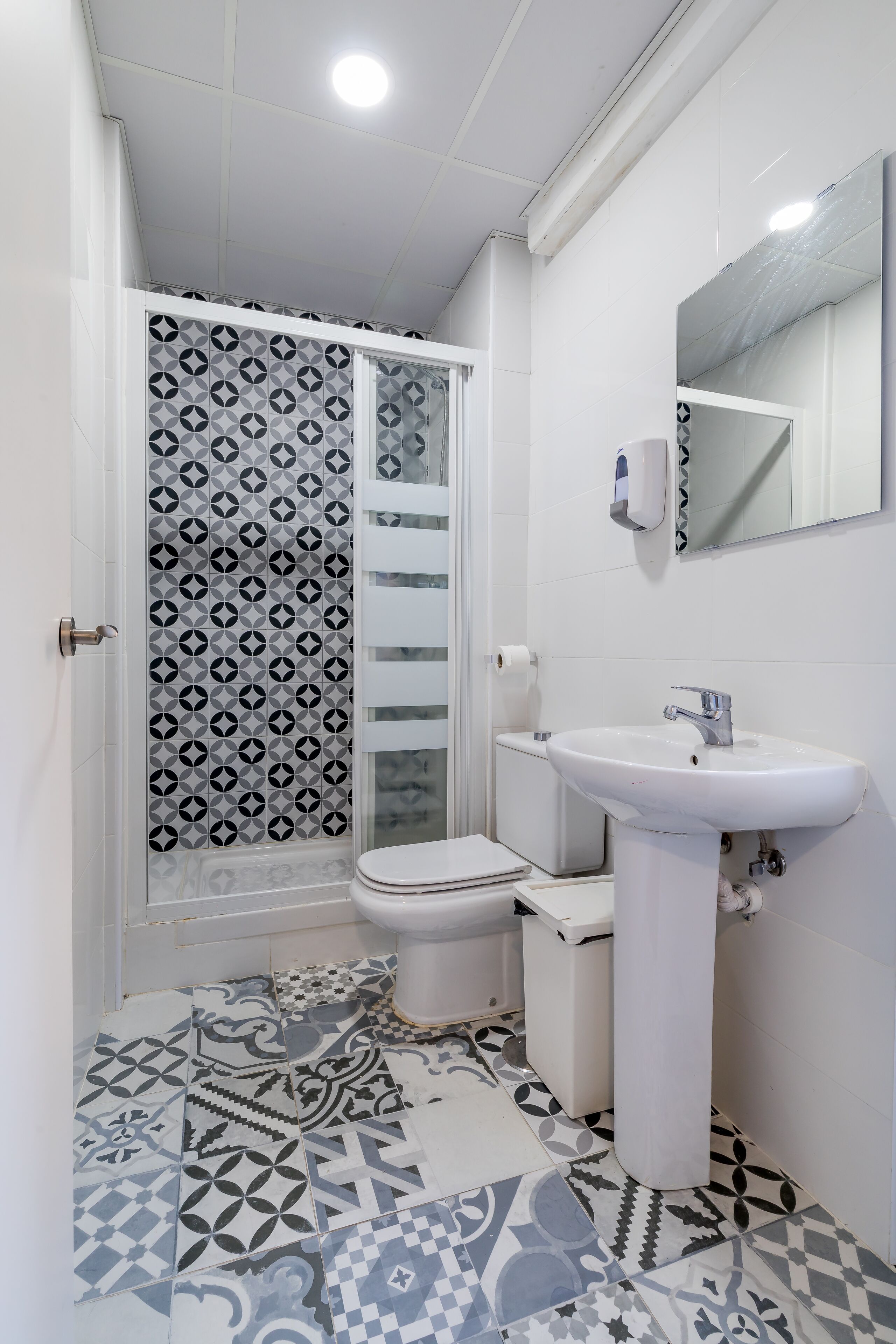 A bathroom with a shower, toilet, and sink.