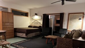 A compact room with a bed, a desk, a chair, a small table, and a sofa. - The Sleepy Shack - Private, Cozy Cottage for your next getaway! (Charleston)