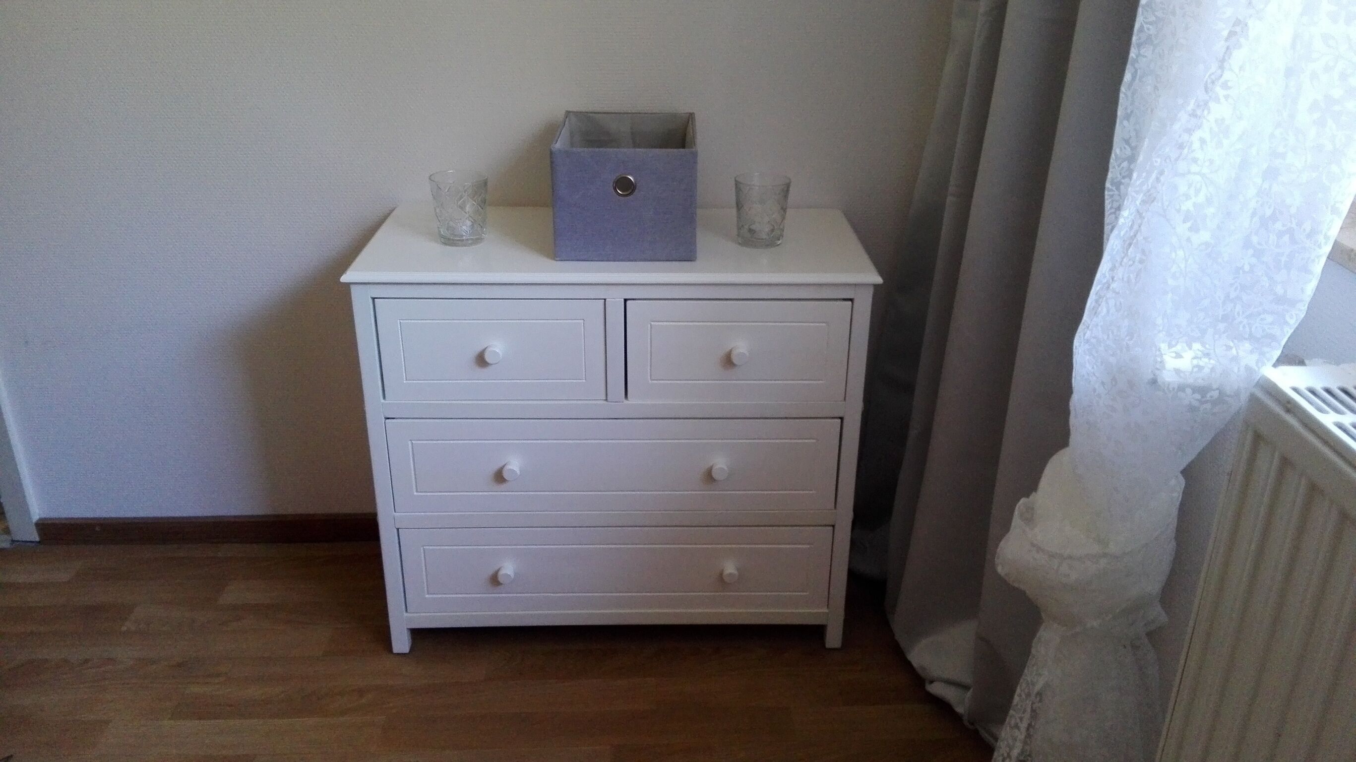 A white dresser with three drawers and a small box on top.