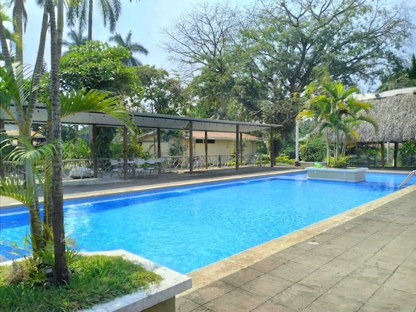 2 outdoor pools, open 7 AM to 10 PM, pool umbrellas