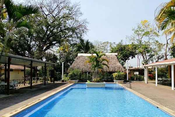 2 outdoor pools, open 7 AM to 10 PM, pool umbrellas