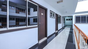 A clean, well-lit corridor with a polished floor, large windows, and a wooden railing. - OYO 89571 Eco Palace Hotel (Kuala Lumpur)