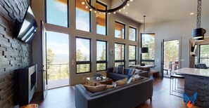 Relax in this spacious living area with a large sofa, fireplace, and dining space.