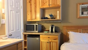 A compact kitchenette with a microwave, coffee maker, and refrigerator. - Cute cozy condo near ski resorts (Park City)
