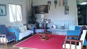 A living room with two sofas, a coffee table, and a patterned floor. - Lady Maria's Place (Pangai)