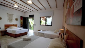 A hotel room with two beds, a large window, and a painting on the wall. - Casa Delia Hotel (Bacalar)
