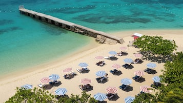 On the beach, white sand, beach umbrellas, beach towels