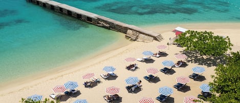 On the beach, white sand, beach umbrellas, beach towels