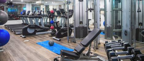 A gym with treadmills, weight machines, and free weights.