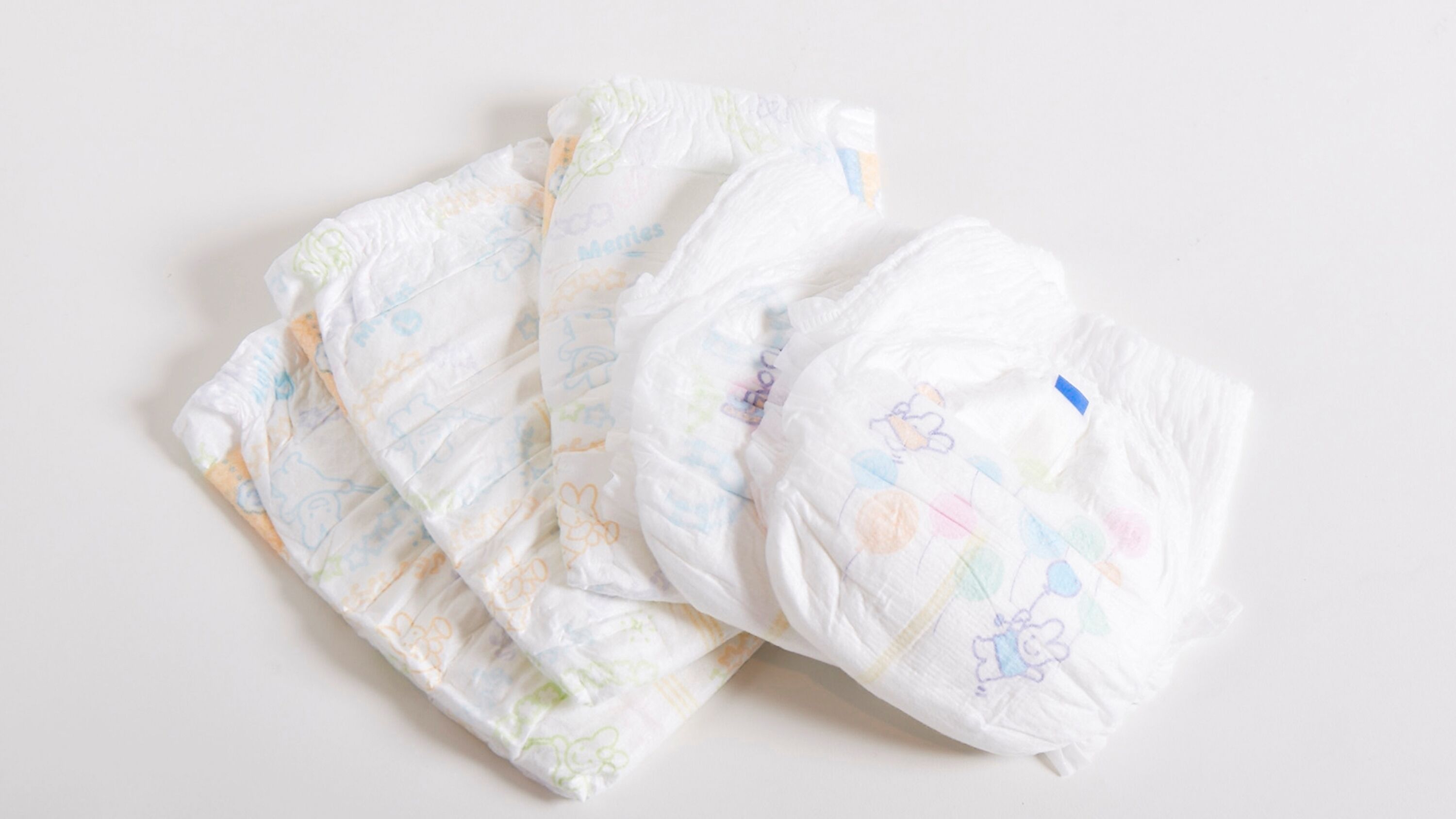 A collection of baby diapers with various patterns and designs.