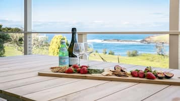Enjoy a romantic evening on the balcony with a stunning coastal view, complete with a wine and snack selection.