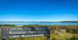 A sign for Jervis Bay National Park and Lake Wollumboola. - Shady Palms – lovingly renovated beach house (Culburra Beach)