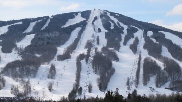 A snow-covered mountain with ski trails. - Mount Snow Mountain Views - Spacious and Clean 4 Bedrooms 3 Baths Condo  (West Dover)