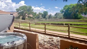 A hot tub with a wooden fence in the background. - Adobe Dreams - 3292, Private hot tub (Moab)