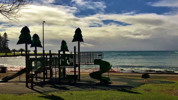 A playground with slides and climbing structures near a beach. - Beachside Getaway - 150 metres to beach (Kiama)