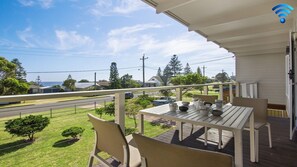 Enjoy dining or relaxing on this outdoor balcony with a view of the surrounding neighborhood.