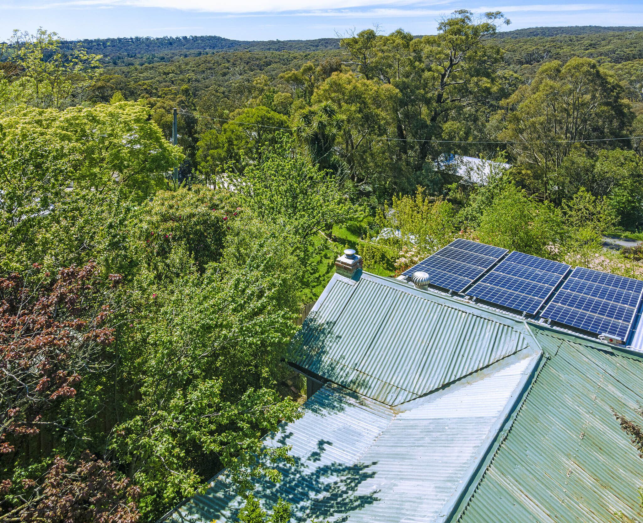A building with a green roof and solar panels.