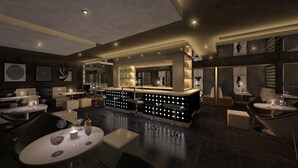 Un área de bar moderna con una barra central, asientos y una iluminación ambiental.